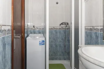 a bathroom with a shower and a toilet and a sink at Trianon, 5º-29 in Cullera