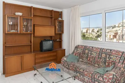a living room with a couch and a tv at Villas Cap Blanc Ii, Pta 11 in Cullera