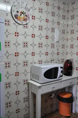 a microwave sitting on a table in a kitchen at Palm Tree Cullera in Cullera