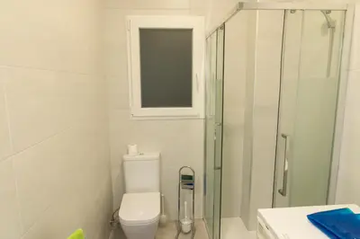a bathroom with a toilet and a glass shower at Apartamento cerca de la Playa y el Centro in Valencia