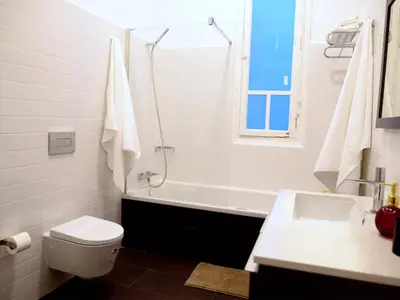 a bathroom with a toilet and a tub and a sink at City Hall Correos in Valencia