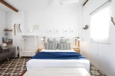 a bedroom with a large white bed with blue sheets at FLORIT FLATS - Ruzafa Attic with Private Terrace in Valencia