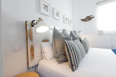a bedroom with a bed with pillows on it at FLORIT FLATS - Ruzafa Attic with Private Terrace in Valencia