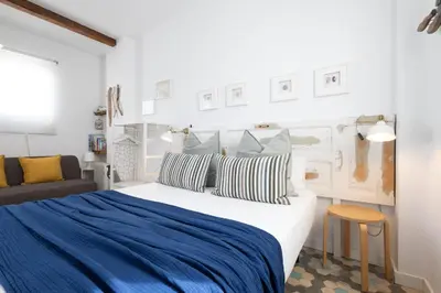 a bedroom with a large bed with a blue blanket at FLORIT FLATS - Ruzafa Attic with Private Terrace in Valencia