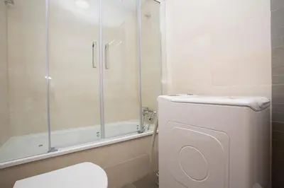 a bathroom with a toilet and a shower at SingularStays Puzol Beach VI in Puzol