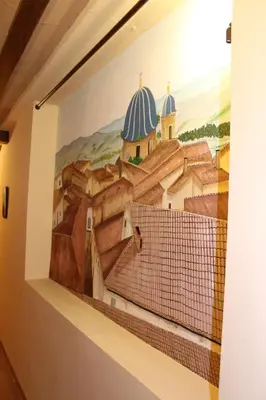 a mural on the wall of a building with roofs at Hotel La Villa in Requena