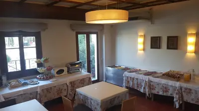 a dining room with two tables and a tableasteryasteryasteryasteryasteryasteryastery at Hotel La Carreta in Chiva