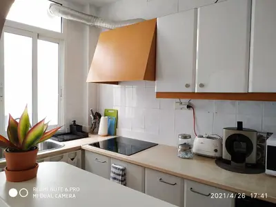 a kitchen with white cabinets and a counter top at La Roqueta completo en pleno centro in Valencia