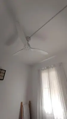 a white ceiling fan in a room with a window at La Roqueta completo en pleno centro in Valencia
