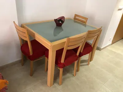 a wooden table with two chairs and a vase on it at Apartamento junto al mar Los Marineros con acceso independiente por terraza in Puzol
