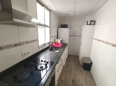 a kitchen with a stove and a refrigerator at Apartamento La Marina Real in Valencia