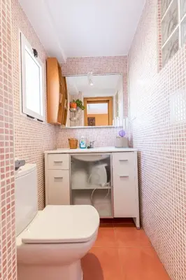 a bathroom with a white toilet and a sink at Apartamento Calipso in El Palmar