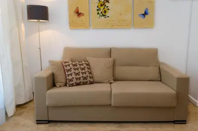 a couch with a pillow on it in a living room at ApartUP Francia Views in Valencia