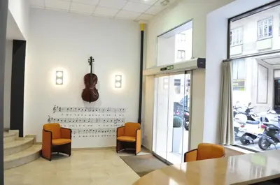a room with a violin on the wall and a table and chairs at Hotel Valencia de la Música in Valencia