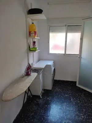 a laundry room with a washer and dryer in it at Apartamento Cuatro Carreres in Valencia