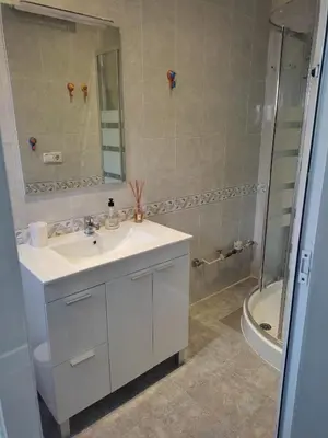a bathroom with a white sink and a shower at Apartamento Cuatro Carreres in Valencia