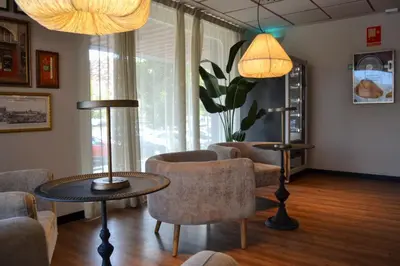 a waiting room with chairs and a table and lamps at Sweet Hotel Renasa in Valencia