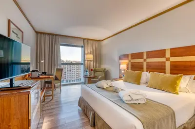 a hotel room with a bed and a desk at Senator Parque Central in Valencia