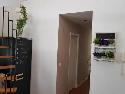 a hallway with a black refrigerator and potted plants at Domus Valencia Apartamentos Casa con piscina privada a 30 minutos de Valencia in Turís