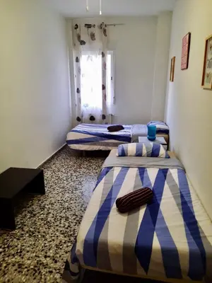 a room with two beds and a window at Piso en la playa in Valencia