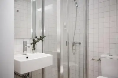 a white bathroom with a sink and a shower at Palacios Rooms in Valencia
