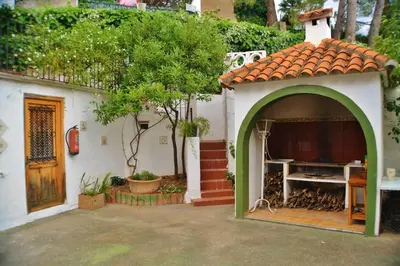 a small house with an archway in a yard at Casa Las Violetas in Altura
