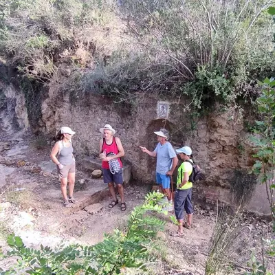 a group of people standing next to a stone wall at Casa Las Violetas in Altura