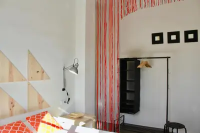 a room with a bed and a red curtain at Apartamento Con Vistas Espectaculares in Valencia