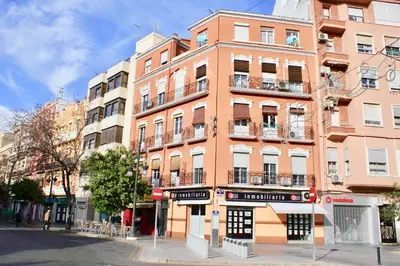 a tall orange building on a city street at Apartamento Con Vistas Espectaculares in Valencia