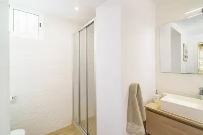 a bathroom with a glass shower and a sink at Vivaldi Center City in Valencia