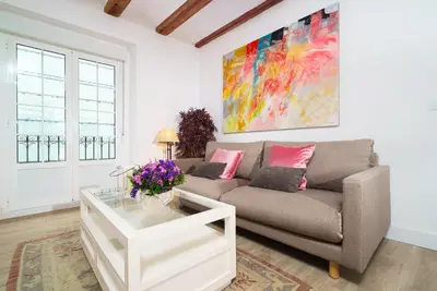 a living room with a couch and a table at Vivaldi Center City in Valencia