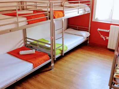 two bunk beds in a room with wooden floors at Feetup Home Backpackers Valencia in Valencia