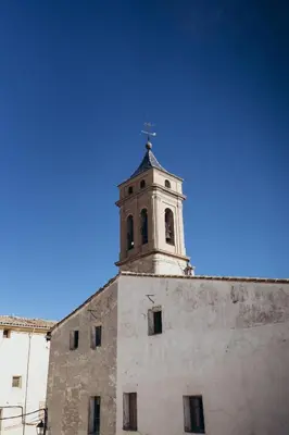 a building with a clock tower on top of it at Hotel Restaurante Doña Anita in Requena