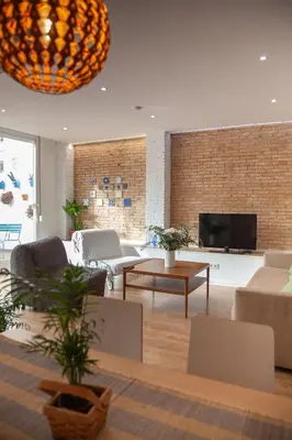 a living room with a couch and a tv at Casa Marcellino Valencia Centro in Valencia