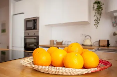 a bowl of oranges on a table in a kitchen at Casa Marcellino Valencia Centro in Valencia