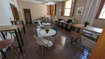 a room with tables and chairs in a room at Hostal El Convent de Moncada in Moncada