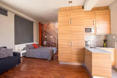 a small room with a bed and a kitchen at Sky Touristic Attic in Valencia