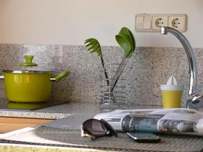 a kitchen counter with a sink with glasses and a faucet at Sky Touristic Attic in Valencia