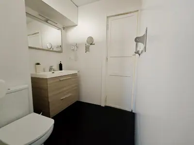 a bathroom with a white toilet and a sink at Hola Valencia - Holiday Apartments in Valencia