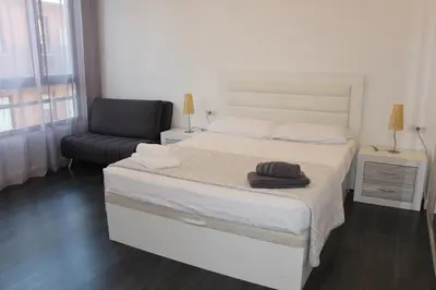 a bedroom with a large bed and a chair at Apartment Sofi in Valencia