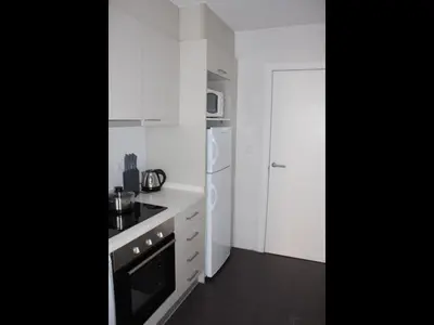 a white kitchen with a stove and a refrigerator at Apartment Sofi in Valencia