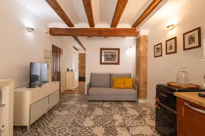 a living room with a couch and a tv at FLORIT FLATS - Charming Ruzafa Apartment & Terrace in Valencia