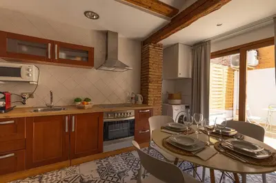 a kitchen with a table and a dining room at FLORIT FLATS - Charming Ruzafa Apartment & Terrace in Valencia