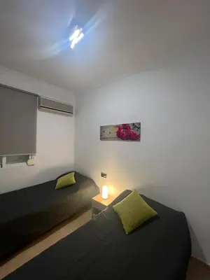 a bedroom with two beds and a window at Calle Mora De Rubielos in Valencia