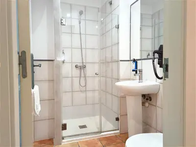 a bathroom with a shower and a sink at Flats Friends Nave in Valencia