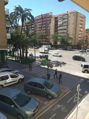 a parking lot with cars parked in a city at Apartamento Turistico en Valencia in Valencia