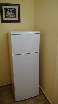 a white refrigerator in a corner of a room at Apartamento Turistico en Valencia in Valencia