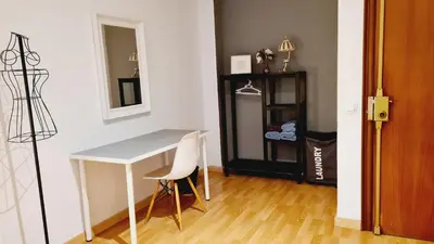 a dining room table with two chairs and a mirror at Santos Studio 2 in Valencia