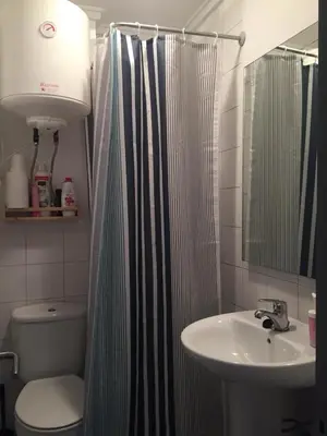 a bathroom with a shower curtain and a sink at Santos Studio 2 in Valencia