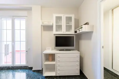 a living room with a tv on a white dresser at Apartamento valencia centro in Valencia